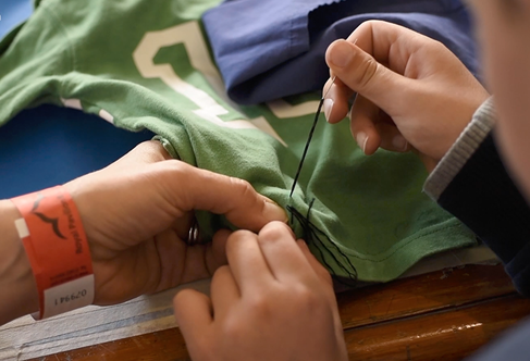 Hands stitching clothes
