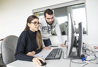 Students look at a computer screen together